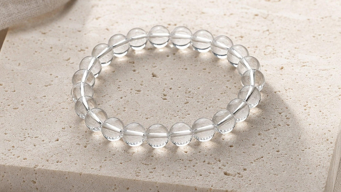 Clear Quartz crystal bracelet on stone slab representing energetic cleansing and charging